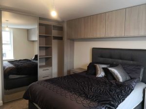 bedroom with sliding wardrobes and cupboards