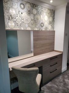 vanity area with mirror and drawers
