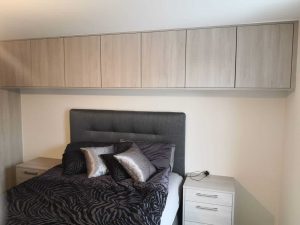 bed with matching bedside tables and cupboards